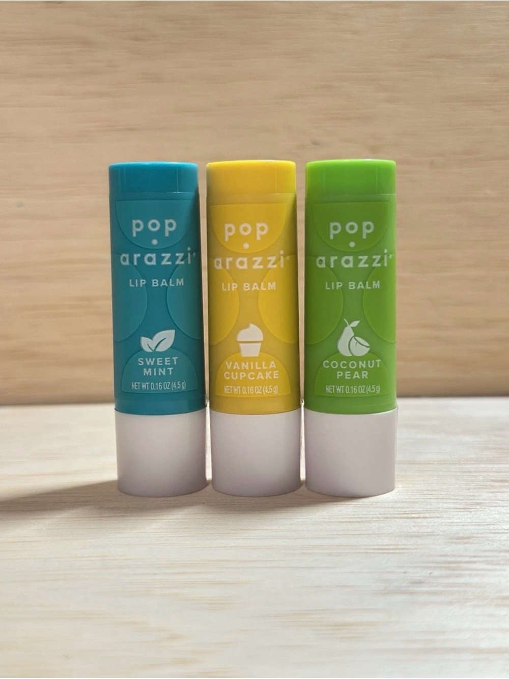 3-Pop Arazzi Lip Balm, 1-Vanilla Cupcake, 1-Coconut Pear & 1- Sweet Mint